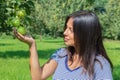 Woman holding and looking at pears in orchard Royalty Free Stock Photo