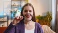 Woman holding magnifier glass on teeth, happy expression, showing funny smiling silly face mouth Royalty Free Stock Photo