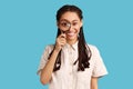 Woman holding magnifying glass and looking at camera with big zoom eye, positive face. Royalty Free Stock Photo