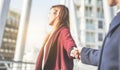 Woman holding man by hand in city urban center - Boyfriend following beloved girlfriend during weekend cityscape holiday - Love