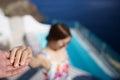 Woman holding man hand while leading him on private pool villa, whitewashed village in Oia, Santorini Greece. mediterranean sea Royalty Free Stock Photo