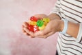 Woman holding many colorful candies on color background Royalty Free Stock Photo