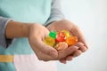 Woman holding many colorful candies on light background Royalty Free Stock Photo