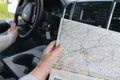 Woman holding map in car on road trip Royalty Free Stock Photo