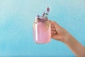 Woman holding mason jar with fresh lavender lemonade on color background, closeup Royalty Free Stock Photo