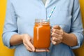 Woman holding mason jar of tasty carrot juice Royalty Free Stock Photo