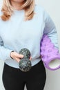 Woman holding massage rollers for myofascial release in her hands. Fitness trainer with items for myofascial release