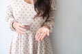 A woman holding a medicine and a glass of water in her hand. Medical and health concepts Royalty Free Stock Photo