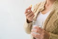 A woman holding a medicine and a glass of water in her hand. Medical and health concepts Royalty Free Stock Photo