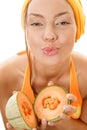 Woman holding melons and kissing