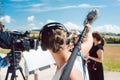 Woman holding microphone on a boom during video production Royalty Free Stock Photo