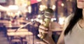 Woman holding microphone in hand on pub and restaurant Royalty Free Stock Photo