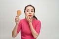 Woman holding a mirror, touch and worrying about her face Royalty Free Stock Photo