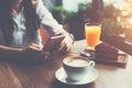 Woman holding mobile phone in hands, texting in social media, breakfast of handsome business lady Royalty Free Stock Photo