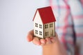 Close Up Of Woman Holding Model Wooden House