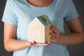 Woman Holding Model Wooden House
