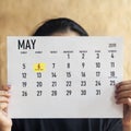 Woman holding Monthly calendar of May. 6th May 2019 marked as Ramadan beginning day Royalty Free Stock Photo