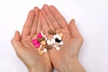 A woman holding multicoloured pills in hands