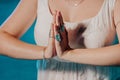 Woman holding namaste in clean water. Palms with gypsy boho rings. Meditation, praying, gratitude, purity background. Royalty Free Stock Photo