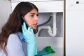 Woman Holding Napkin Under Sink Pipe Leakage Calling Plumber Royalty Free Stock Photo
