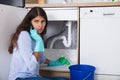 Woman Holding Napkin Under Sink Pipe Leakage Calling Plumber