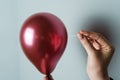 Woman Holding a Needle Close to a Balloon to Pop Royalty Free Stock Photo