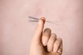 Woman holding needles for acupuncture on pink background, closeup Royalty Free Stock Photo