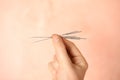 Woman holding needles for acupuncture on pink background, closeup Royalty Free Stock Photo