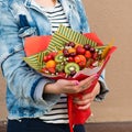 Woman holding fruit bouquet