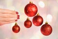 Woman holding New Year round balls ready to decorate tree