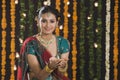 Woman holding an oil lamp on Diwali