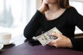 Woman holding a one hundred dollar bill Royalty Free Stock Photo