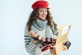 Woman holding opened parcel and checking delivered sweater Royalty Free Stock Photo