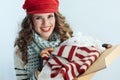 Woman holding opened parcel and checking delivered sweater Royalty Free Stock Photo