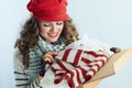 Woman holding opened parcel and checking delivered sweater Royalty Free Stock Photo