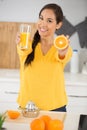 woman holding orange and glass juice