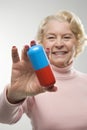 Woman holding oversized pill. Royalty Free Stock Photo