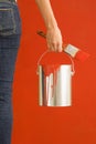 Woman holding paint can.