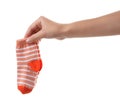 Woman holding pair of cute child socks on white background Royalty Free Stock Photo