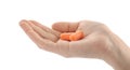 Woman holding pair of orange ear plugs on white background, closeup Royalty Free Stock Photo