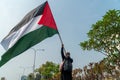 a woman holding a Palestinian flag