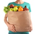 Woman holding paper bag with different groceries on white background Royalty Free Stock Photo