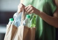 Woman holding paper bag with used plastic. Generate Ai