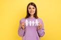 Woman holding paper chain people which holding in hands, happy family, relationships. Royalty Free Stock Photo