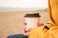 Woman holding a paper coffee cup in her hand, women with the cup of coffe Royalty Free Stock Photo