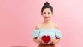 Woman holding paper heart shaped card . Valentine day concept . I`m looking waiting for partner ! Advertising people person