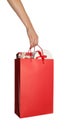 Woman holding paper shopping bag full of gift boxes on white background Royalty Free Stock Photo