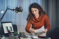 Woman holding papers in her hands, calculating family budget at home Royalty Free Stock Photo