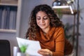 Woman holding papers in her hands, calculating family budget at home Royalty Free Stock Photo