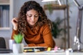 Woman holding papers in her hands, calculating family budget at home Royalty Free Stock Photo